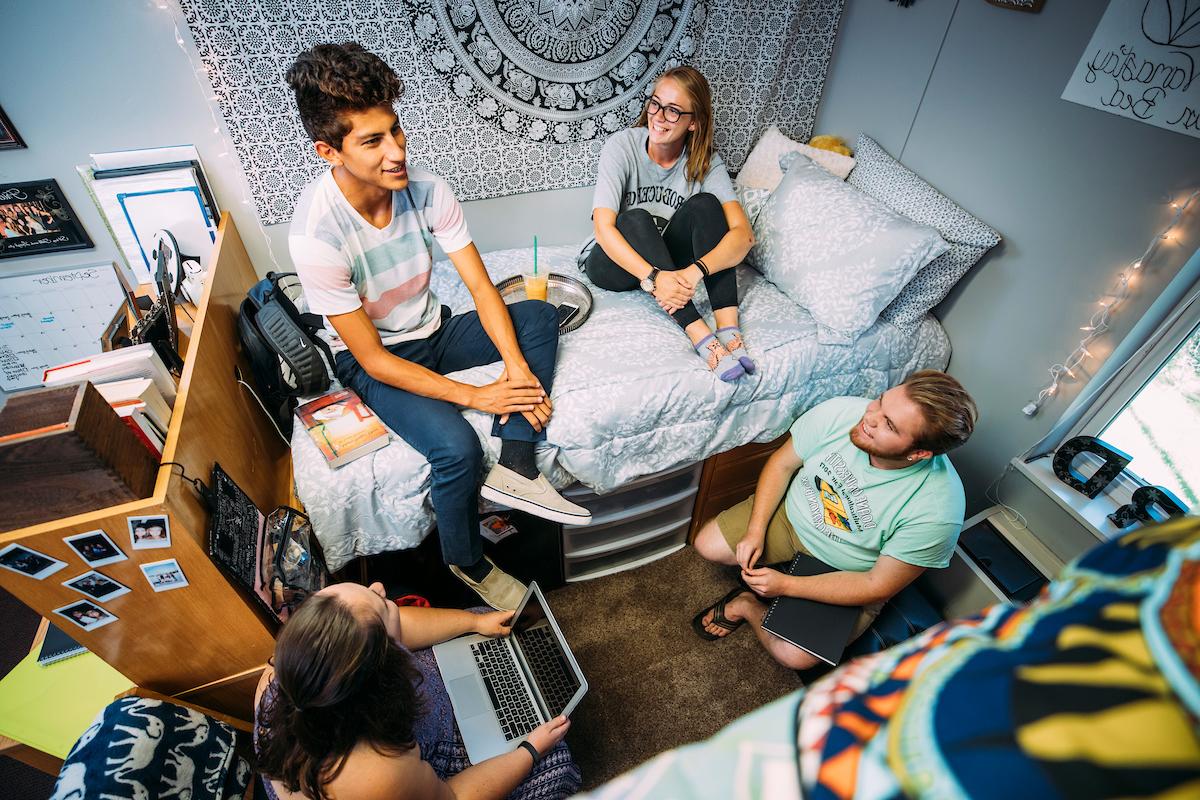 Overhead shot of Doane students relaxing in a dorm room.